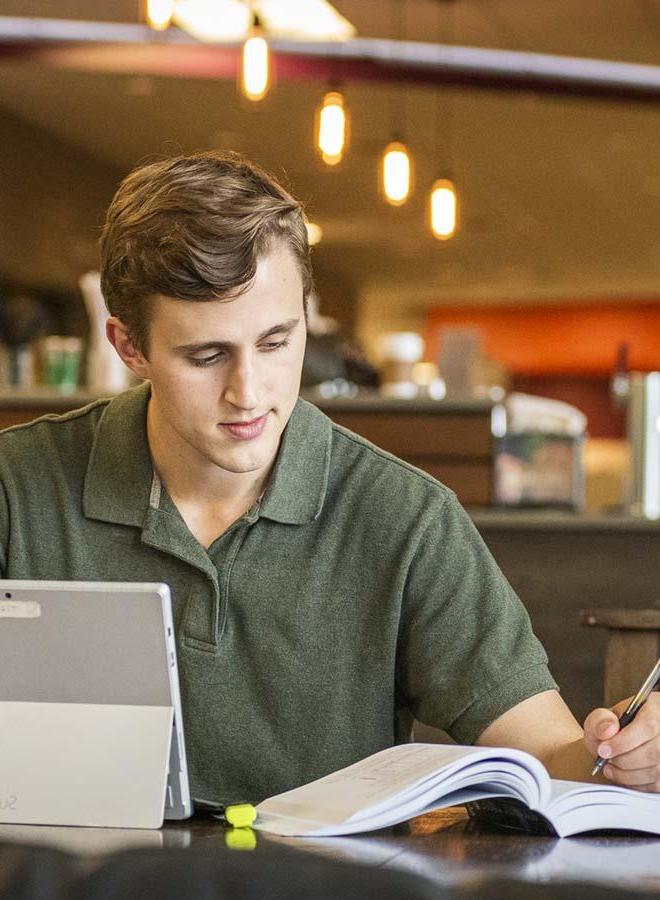 Adult student studying at the a coffee shop